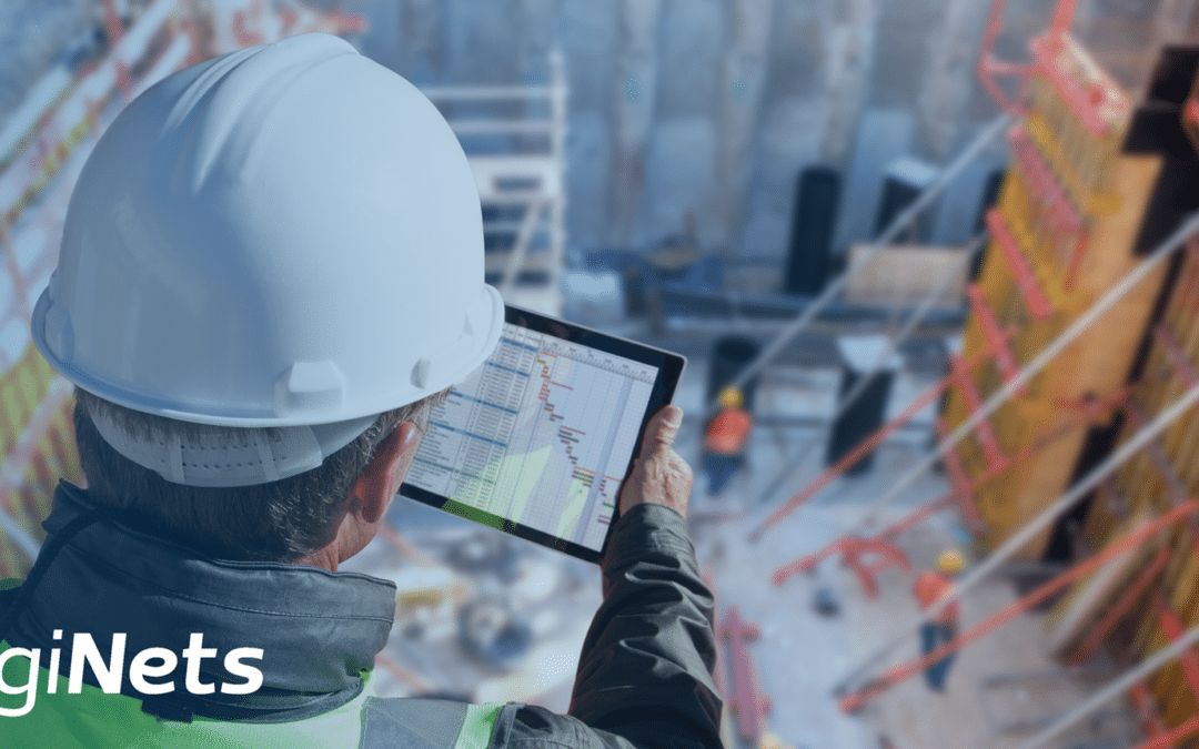 Site manager wearing a hard hat checking his work orders on a tablet.